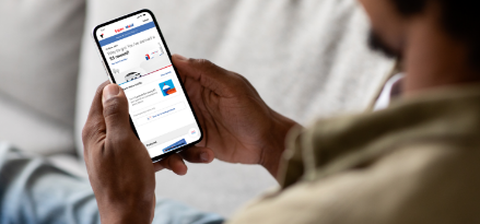 Man using the Exxon Mobil Rewards+ app on a smartphone