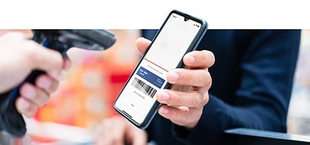 Cashier scanning Exxon Mobil Rewards+ gas app