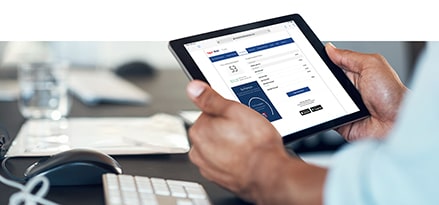 Image showing a person viewing their fuel rewards on Exxon Mobil Rewards+ gas app on tablet