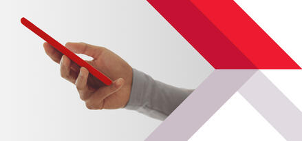 Hand holding a red smartphone