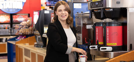 Female c-store customer getting coffee