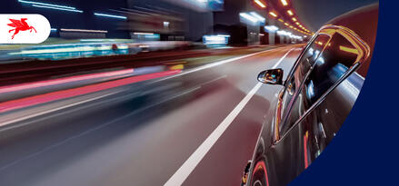 Glimpses of light streaks and the road as a car speeds down the road