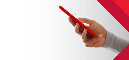 Hand holding a red smartphone