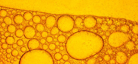 A close up of light, caramel-colored fuel, showing its bubbles