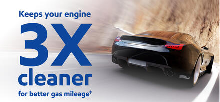 A black car racing down a narrow road against the mountainside with text: Keeps your engine 3X cleaner for better gas mileage‡