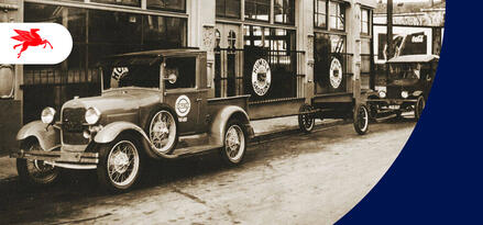 An old photograph featuring vintage automobiles with visible Humble Gasoline signage.